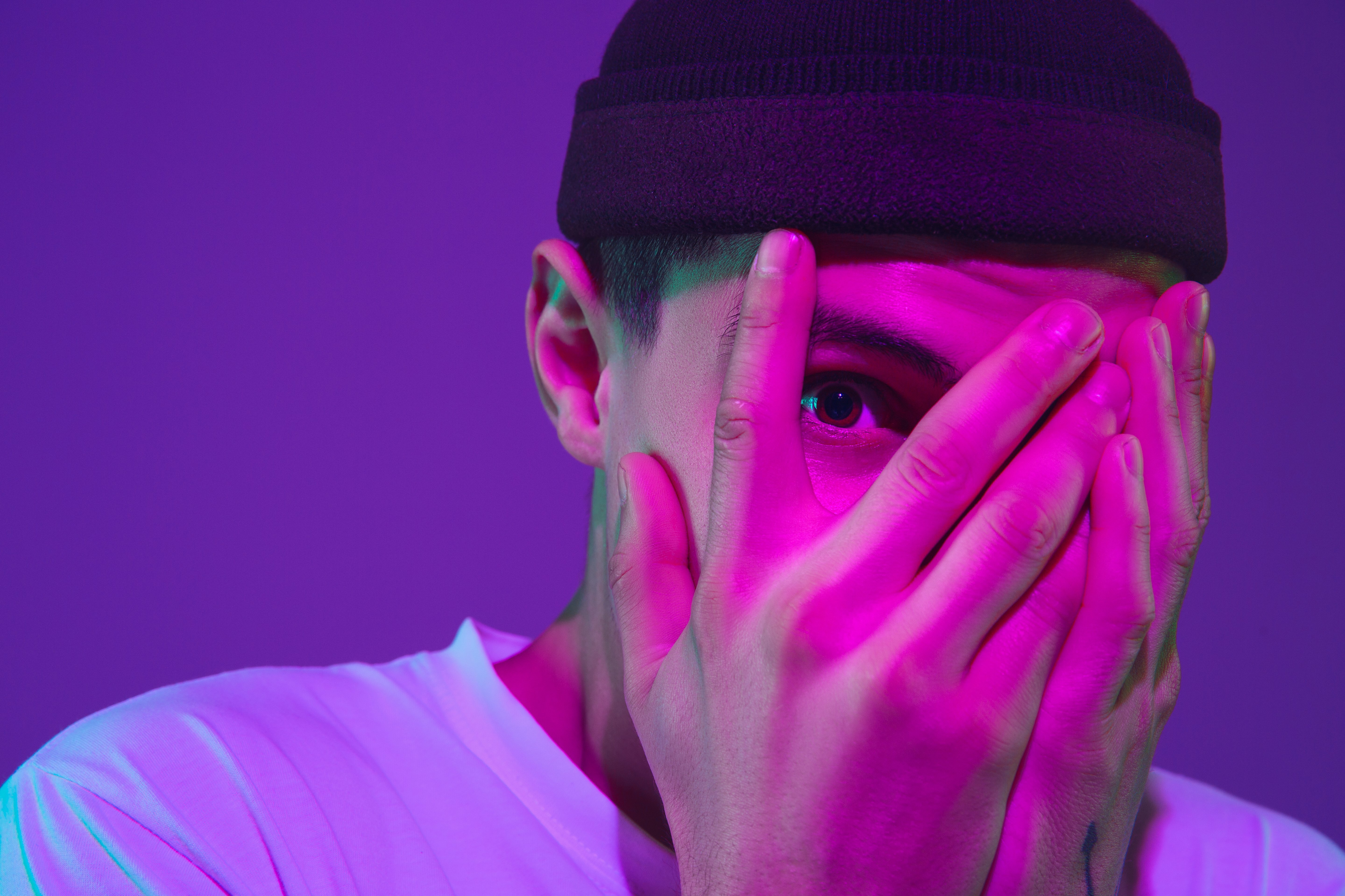 caucasian-man-s-portrait-isolated-purple-studio-neon-light
